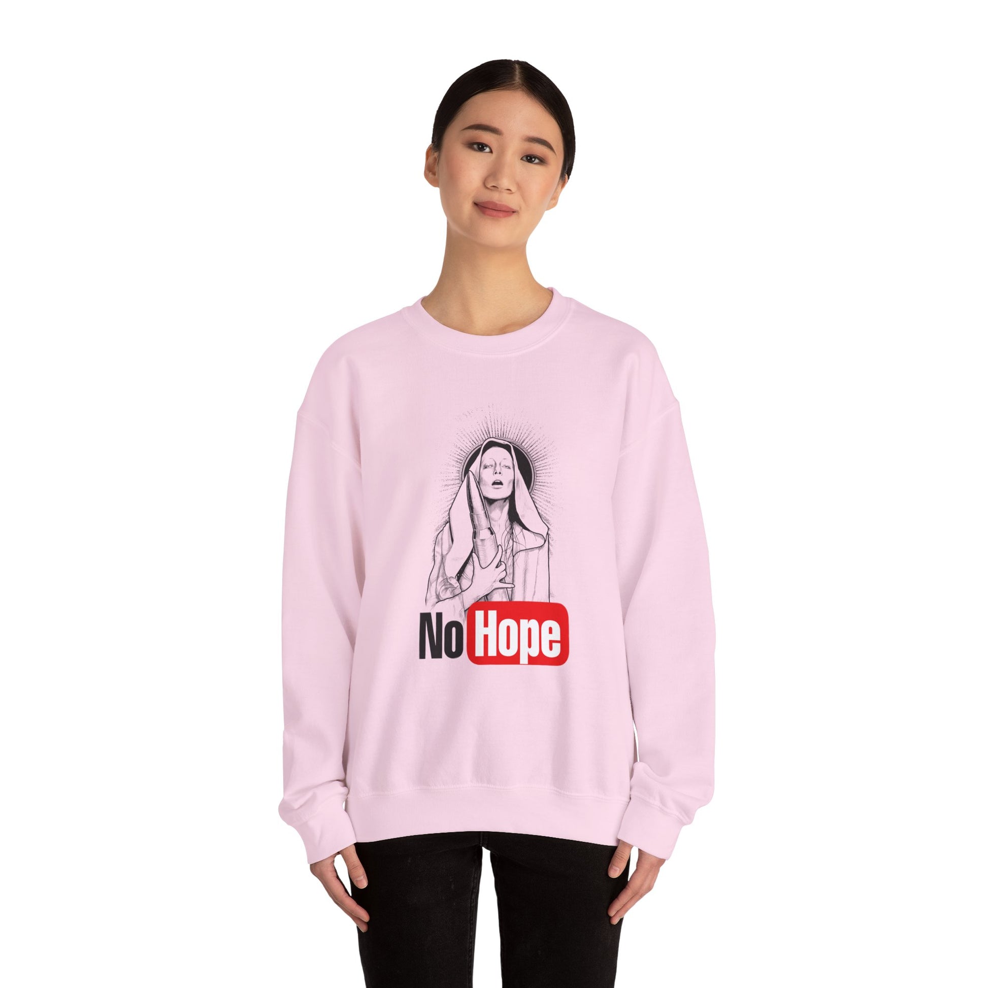 woman wearing light pink crewneck sweatshirt with a graphic print of a person and the text 'No Hope' on the front, front