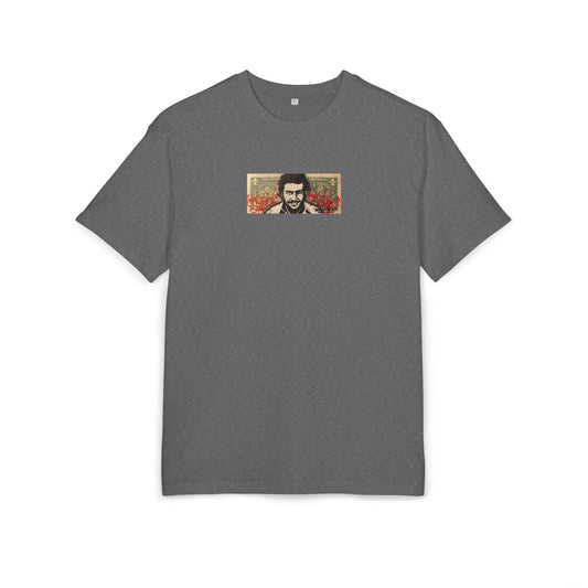 Gray t-shirt with a small graphic dollar desing of pablo escobar on the chest against a white background, front