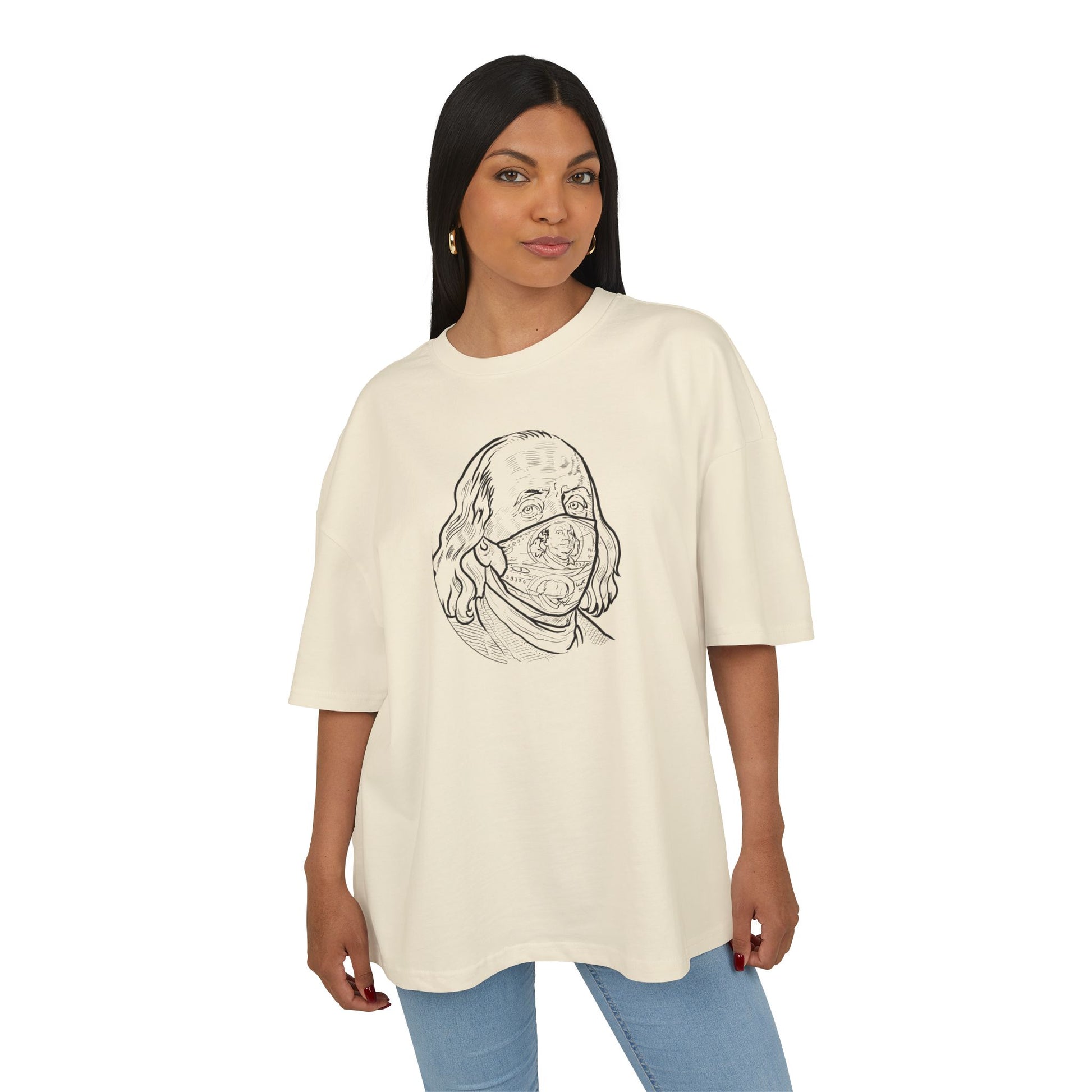 Woman wearing a sand t-shirt with a graphic design on a white background, front