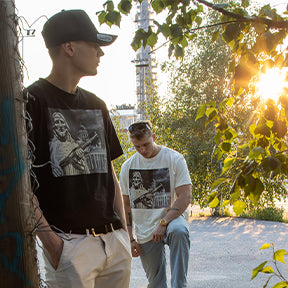 2 men wearing black and white t shirt with aristic graphic design